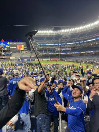 While most of the home team fans quickly exited, one long time Yankee rooter sat back and watched the Dodgers celebrate. And even befriended some of the Dodgers fans.