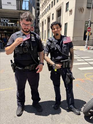 Cops with American flags on duty at the Independence Day Parade.