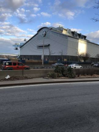 Twilight falls on the East 91st Street Marine Transfer Station on Sunday, March 4th. Loathed by locals since it was proposed nearly 15 years ago, the MTS will now process far less trash than originally projected — and the number of garbage trucks rumbling across the East Side will also plummet. Photo: Douglas Feiden
