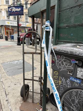 Crime scene tape still affixed to sign post outside Pretty Ricky bar on Aug. 17.
