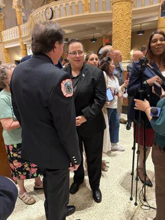 Retired FDNY firefighter and artist Dennis Burke with FDNY Commissioner Lillian Bonsignore, Letitia James at right.