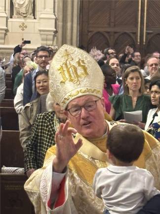 Cardinal Timothy Dolan blesses a youngster before the start of Easter Sunday Mass at St. Patrick’s Cathedral on April 20.