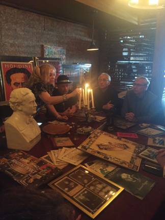 Dorothy Dietrich lights the candelabra before leading the séance with a few moments of silence. Photo: Carson Kessler