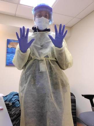 Kellie Bryant poses in personal protective equipment (PPE). She has created a simulation to show students how to properly suit up in the PPE.