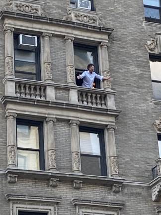 Brian Stokes Mitchell singing from his balcony on Broadway and 98th Street. Photo: Stephan Russo