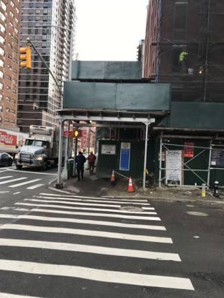 Legislation before the City Council would require sidewalk sheds to be dismantled within six months of being erected — or in seven days if no work has been performed in that time. This scaffolding at Second Avenue and 92nd Street has cast shadows at that corner for years. Photo: Douglas Feiden 
