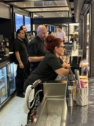 An enthused bar staff awaits orders for handcrafted cocktails, beer, wine, and other beverages on Tracks GCM’s first day, Sept. 2, 2025.