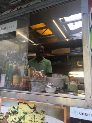 Godshelter Oluwalogbon inside his food truck. Photo: Carson Kessler