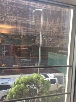 The view from a second-floor apartment of the Hardenbrook House, at 404 East 66th Street, shows a streetlight that is set to host a new wireless cellular antenna. Residents, concerned about the impact of radiation on an elementary school (in background across the street), are trying to stop it. Photo courtesy of Anat Rosenberg