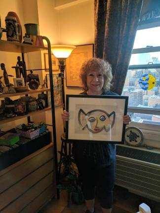 Eileen Millan at home in the Vermeer, with a framed painting of her iconic image. Photo: Liz Hardaway