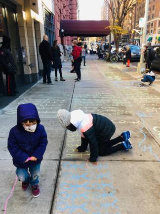 Drawing stick figures on the West 79th Street sidewalk near the Lucerne Hotel. Photo: Upper West Side Open Hearts