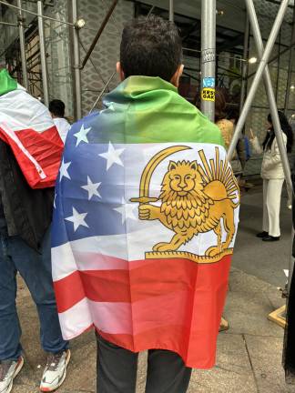 A spectatory wraps himself in the ancient flag of Iran at the Persian Day Parade on Madison Avenue, April 19.