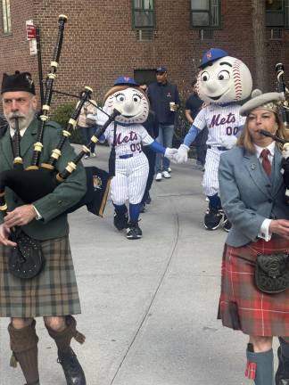 Bagpipers and Mr. and Mrs. Met lead the Opening Day parade at the start of the 75th season of the Peter Stuyvesant Little League.