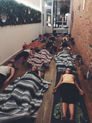 Evening yoga class at Medicine for the Soul, three weeks after the studio’s grand opening on October 1st. Photo courtesy of Amanda Vasquez