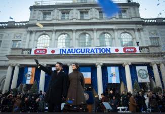 Mayor Zohran Mamdani waves to supporters at his swearing-in ceremony at City Hall on Jan. 1. He was accompanied by his wife, Rama Duwaji, who held the Quran as he was sworn in as the first ever Muslim mayor.