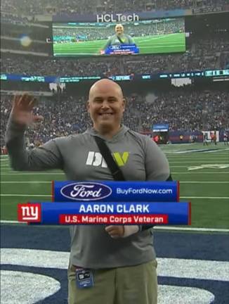 Aaron Clark Marine Corps veteran during November 2023 military moment at Giants Stadium.