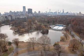 A wintertime photo of the Harlem Meer in Central Park, looking south and east, with the twin ovals that comprise the existing Lasker skating rink.