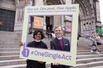 Rev. Winnie Varghese (left) and Bishop Matthew Heyd in front of the Cathedral of St. John the Divine.
