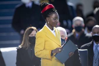 Amanda Gorman steps to the podium to recite her inaugural poem, “The Hill We Climb,” during the 59th Presidential Inauguration ceremony in Washington, Jan. 20, 2021. DOD Photo by Navy Petty Officer 1st Class Carlos M. Vazquez II, via Office of Chairman of the Joint Chiefs of Staff on Flickr