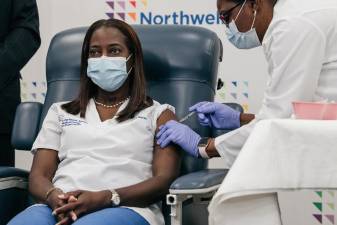 Sandra Lindsay, a registered nurse and Director of Critical Care at Northwell Health in Queens, receives the COVID-19 vaccine during a live conference with Governor Andrew M. Cuomo on December 14, 2020. Photo: Scott Heins/Office of Governor Andrew M. Cuomo