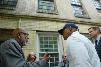 Author and activist Eric K. Washington (far left), celebrates with New York City Mayor Eric Adams (center) and Council Member Eric Bottcher (far right) on a visit to former Colored School #4 in Chelsea on Tuesday, May 23, following its approval as an official city landmark. Photo: Michael Appleton/Mayoral Photography Office