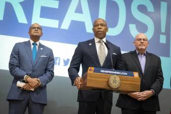 Mayor Eric Adams (at mic) and Department of Education CEO David Brown (right) are pushing a return to a phonics based system, since reading scores in NYC elementary schools have declined under the old system. Michael Mulgrew (left), head of the United Federation of Teachers, said teachers endorsed the sweeping change in the way reading will be taught going forward. Photo: Ed Reed/Mayoral Photography Office