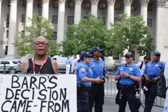 Police and a demonstrator at a July rally protesting the death of Eric Garner.