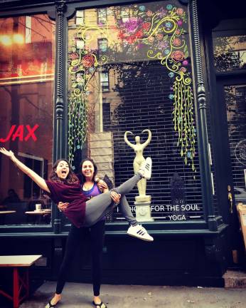 Sisters Amanda (red shirt) and Krysten (purple shirt) Vasquez outside Medicine for the Soul after completing set up of the studio. Photo courtesy of Amanda Vasquez
