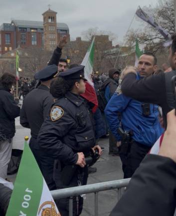 A vigil attendee performs a Nazi salute.