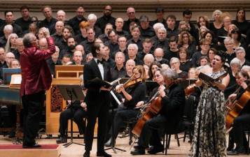 Maestro Ken Tritle (in red jacket) directs soloist Kathryn Lewek (right). As the finale wrapped up, he took her in his arms and planted a kiss on her cheek.