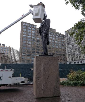 Duarte Square monument gets Parks Department Summer Glow-up. Here a worker from the monuments crew uses blowtorch and polishing tower to make Duarte shine.