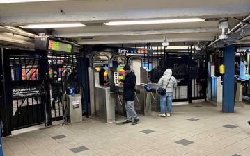 <b>At the east side of Broadway entrance to the Columbus Circle subway station, a current turnstile array provides little challenge to fare evaders who wish to jump over or scoot under the turnstiles, or wait for someone to exit through the emergency gate. </b>Photo: Ralph Spielman