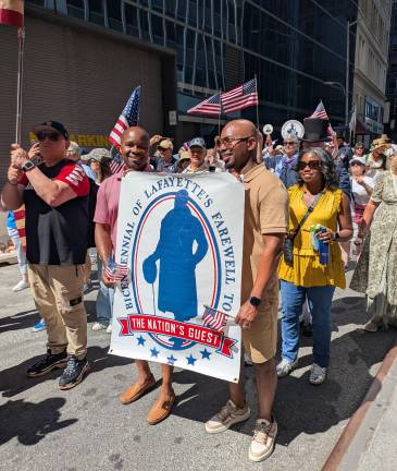 Men holding Lafayette’s Farewell Tour banner.