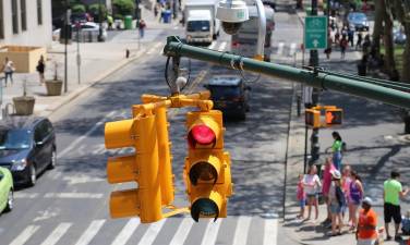 The NYC DOT says it plans to install red light cameras at 450 more city intersections by the end of the year.