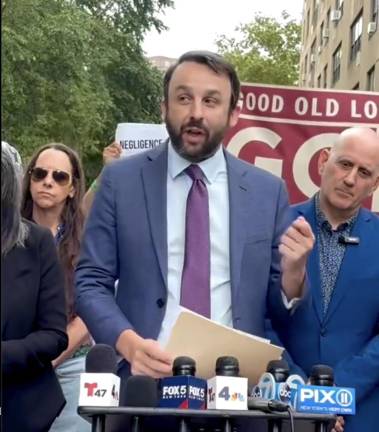 Assemblymember Keith Powers behind him, Council Member Harvey Epstein to his left, speaks at Haven Plaza rally on July 30.