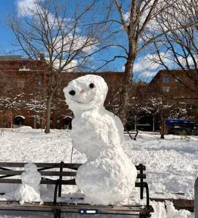 A snow man sits on a park bench at Hudson Piers on Tuesday, Feb. 24.