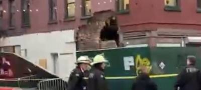 Firefighters on the scene after a partial wall and chimney collapse at 188 Grand St. in Little Italy left a gaping hole in the wall. The Building Department said the entire four structure is unstable and most be demolished. Photo: Citizen App