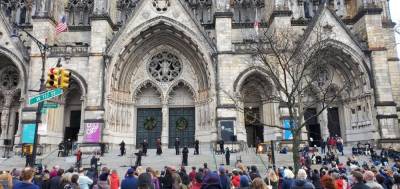 A chorus performing Carols for the Community outside St. John the Divine Sunday afternoon before a gunman opened fire near the crowd. Photo: J. Alex Tarquinio