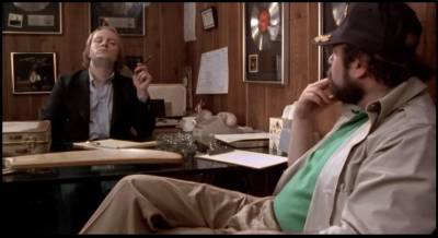 Documentary filmmaker Marty DiBergi (Rob Reiner, right) interviews Spinal Tap manager Ian Faith (Tony Hendra).