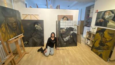 Zhenya Gershman surrounded by her paintings.