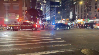 Police and firefighters responding to the scene of a fatal shooting in the Times Square area on the evening of June 4. One person was killed. A second homicide had been reported in Chelsea a short distance away only 90 minutes earlier.