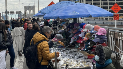 The approach to Brooklyn Bridge is lined with many vending stalls–too many, says DOT.