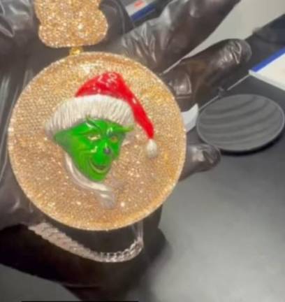 Photo of the Grinch chain which prosecutors said was worn by Julian “JuJu” Pomales, the alleged ringleader leader of a gang that targeted intoxicated men at Manhattan nightclubs and stole their phones and credit cards to make expensive purchases.