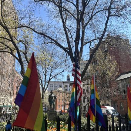 The iconic Pride flag at the center of the Stonewall Monument