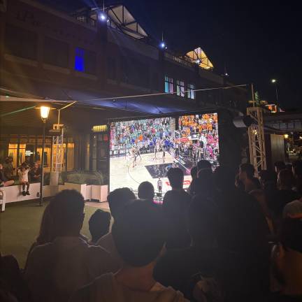 Fans watch Knicks vs San Antonio Spurs on a giant screen at the South Street Seaport.