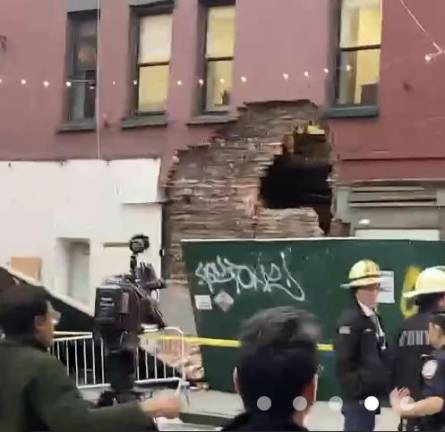 <b>Firefighters on the scene on Jan. 10 after the wall and chimney that was undergoing an illegal renovation at 188 Grand Street collapsed. Until last year, it was the home of Alleva Cheese, which was forced to relocate to New Jersey after 130 years at this address.</b> Photo: Citizens app