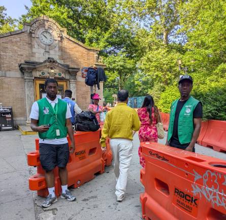 Tour guide ticket scammers wait for their prey outside the Bowling Green subway station.