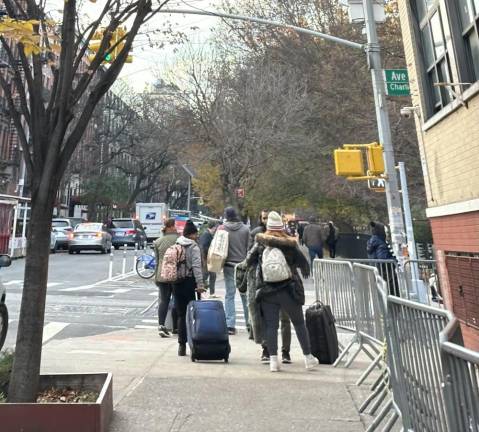 Estephanie (on the left) and Clarissa (on the right) leaving the check in center at the former St. Brigid School in the East Village for a shelter in Queens.