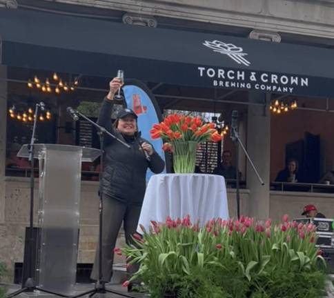 <b>First Deputy Parks Commissioner Iris Rodriguez-Rosa waters the newly anointed variety of tulip with some bubbly at the first annual Tulip Day festival in Union Sq. on April 7</b> Photo: Courtesy Jill Brooke/Flower Power Daily