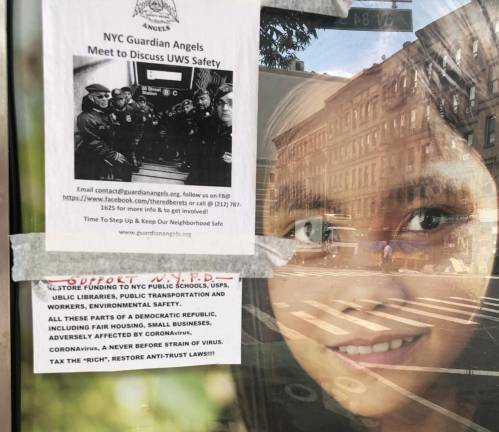 A flyer advertising a Facebook group focused on “neighborhood safety” on the UWS hangs in a bus shelter on Broadway. Photo by Mike Oreskes.